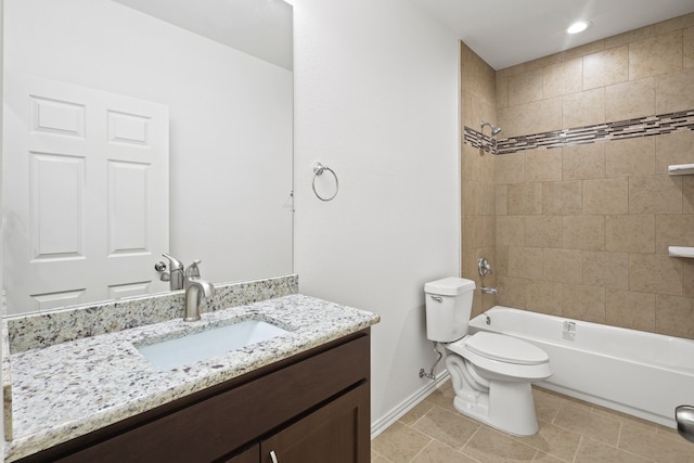 full bathroom featuring tile patterned flooring, vanity, tiled shower / bath combo, and toilet