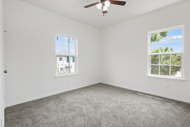 unfurnished room featuring carpet, plenty of natural light, and ceiling fan