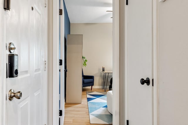 hallway with light hardwood / wood-style floors