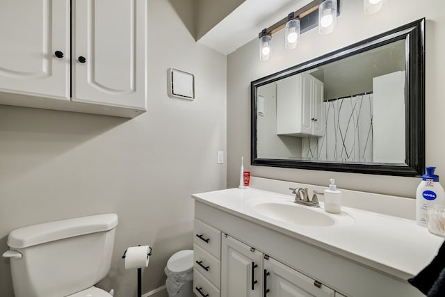 bathroom featuring toilet and vanity