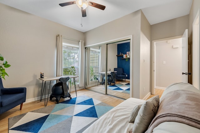 bedroom with ceiling fan, a closet, and light hardwood / wood-style floors