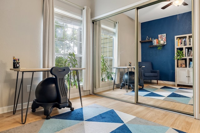 office space with light wood-type flooring and ceiling fan