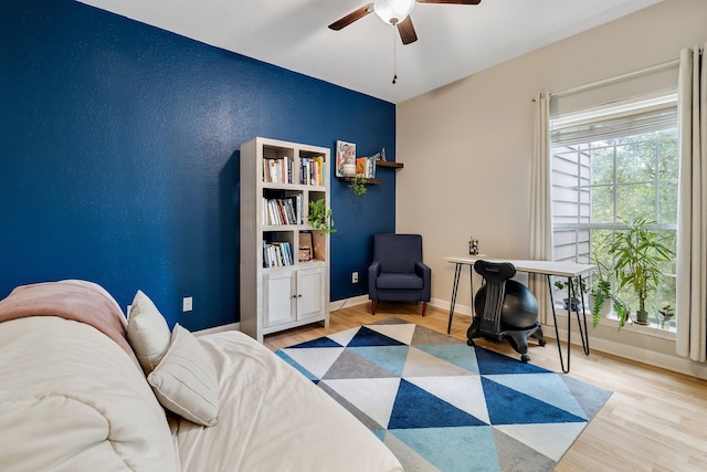 living area featuring ceiling fan and light wood-type flooring