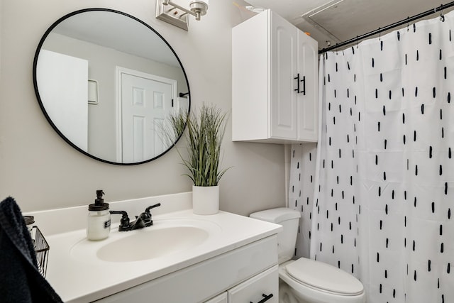 bathroom with vanity, toilet, and walk in shower