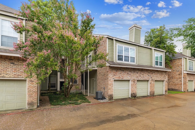 view of front of home featuring central AC and a garage