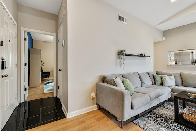 living room featuring lofted ceiling and wood-type flooring