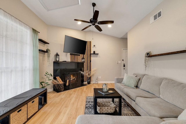 living room featuring vaulted ceiling, ceiling fan, and hardwood / wood-style floors