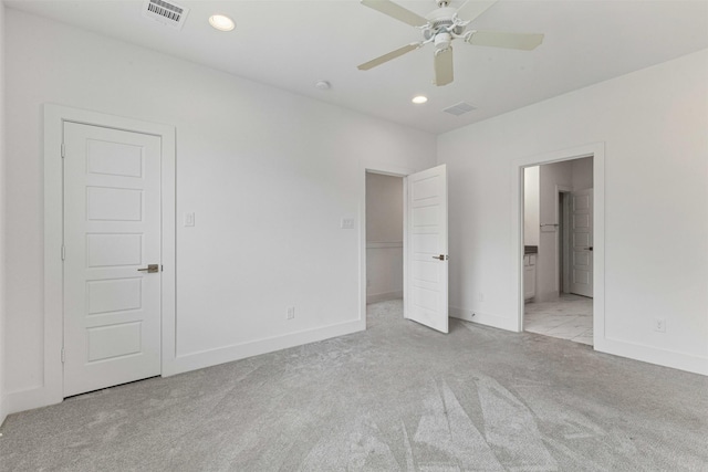 unfurnished bedroom featuring carpet floors, baseboards, recessed lighting, and visible vents