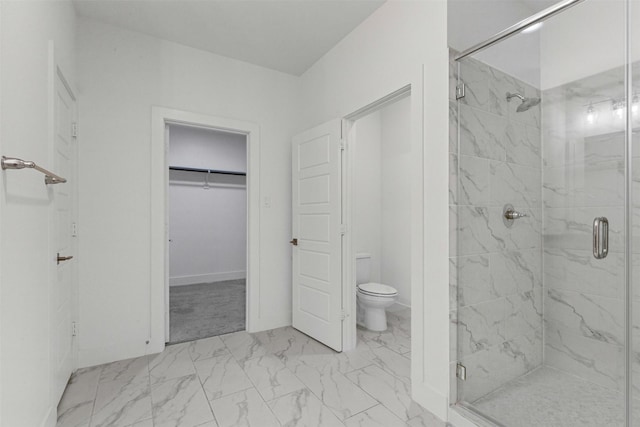 full bath with marble finish floor, a spacious closet, toilet, and a shower stall