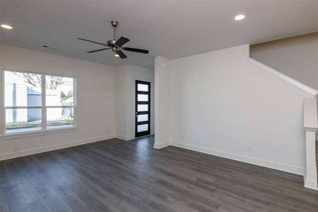 unfurnished living room featuring dark hardwood / wood-style flooring and ceiling fan