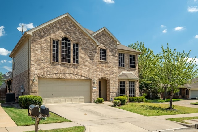 view of front of property featuring a front lawn and a garage