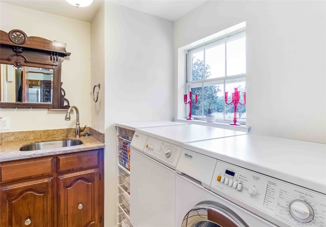 laundry room featuring washing machine and dryer and a sink