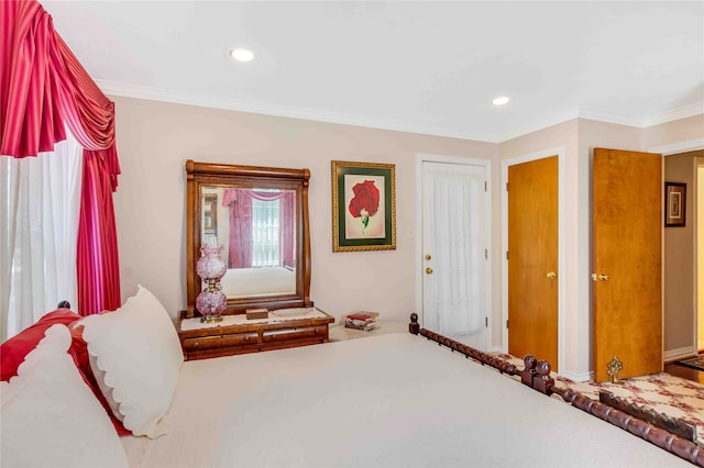 bedroom with ornamental molding and recessed lighting