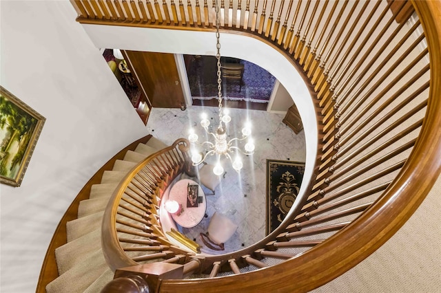 staircase with a chandelier