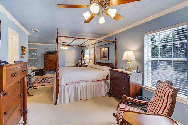 bedroom featuring ornamental molding, multiple windows, visible vents, and light colored carpet