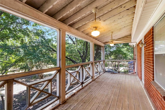 unfurnished sunroom with lofted ceiling