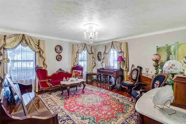 living area featuring a chandelier, ornamental molding, a textured ceiling, and wood finished floors