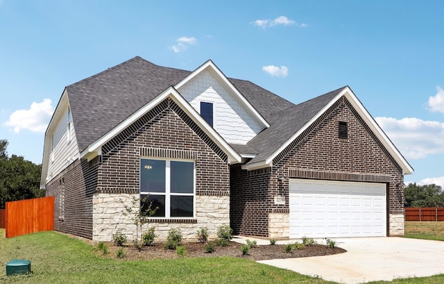 view of front of home with a front yard and a garage