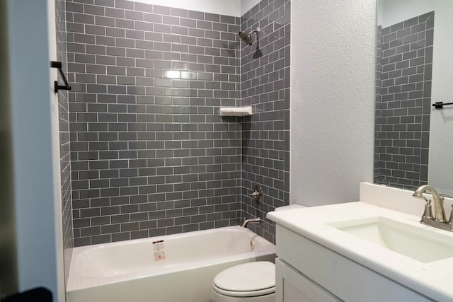 full bathroom featuring tiled shower / bath, vanity, and toilet