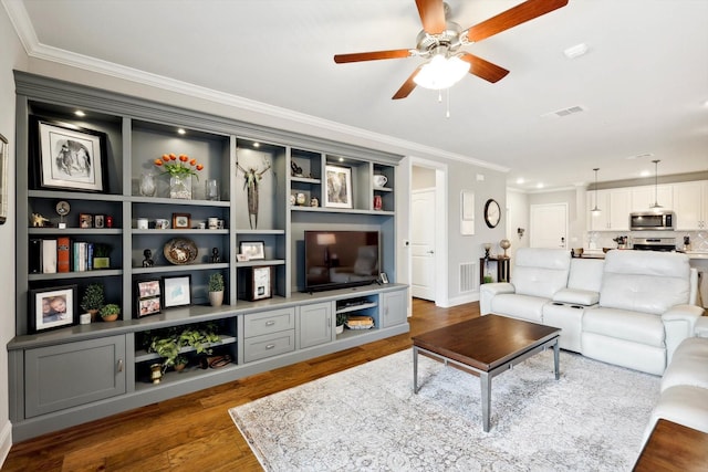 living room with ceiling fan, ornamental molding, and hardwood / wood-style floors