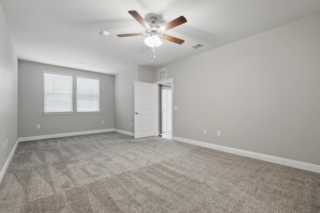 unfurnished bedroom with ceiling fan, carpet floors, visible vents, and baseboards