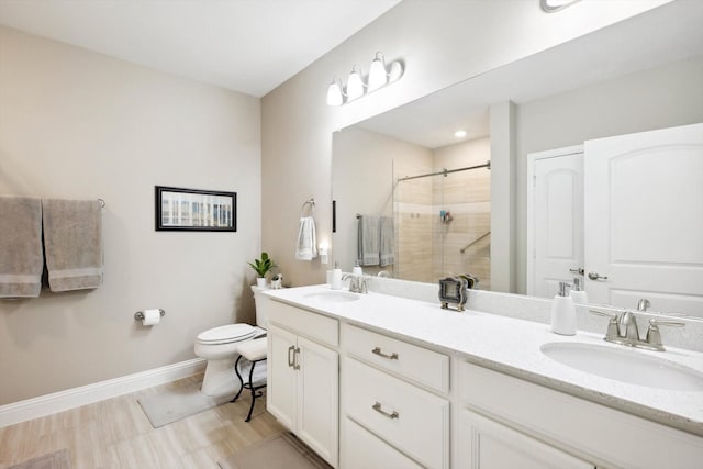 bathroom featuring vanity, toilet, and a shower with door