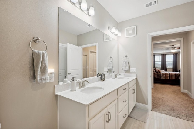 bathroom with ceiling fan and vanity