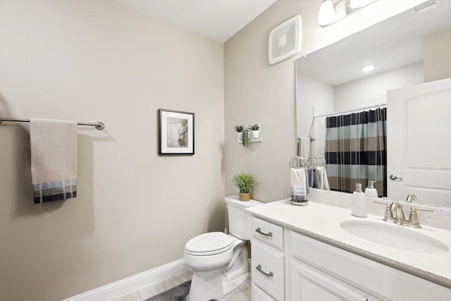 bathroom featuring toilet, vanity, and a shower with shower curtain