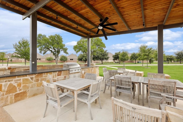 view of patio with ceiling fan, area for grilling, and outdoor dining space