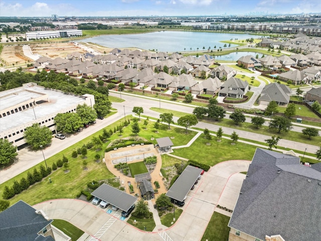 drone / aerial view featuring a water view and a residential view