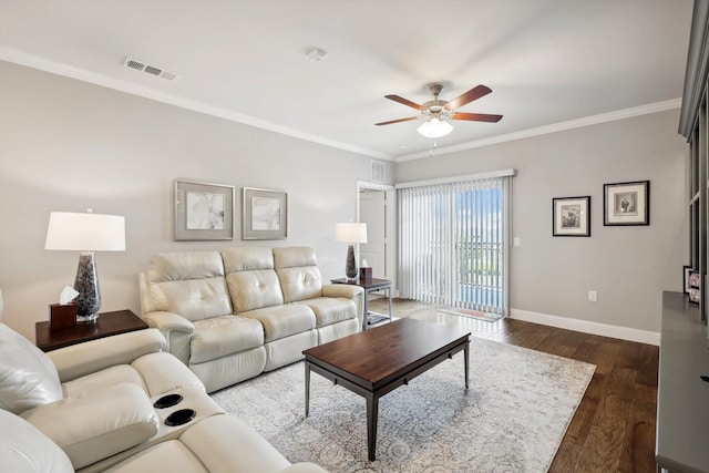 living room featuring dark wood-style floors, visible vents, ornamental molding, and baseboards