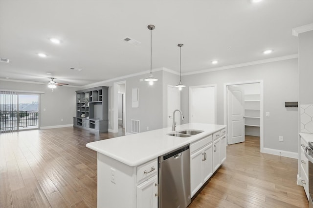 kitchen featuring visible vents, a sink, light wood finished floors, and stainless steel dishwasher