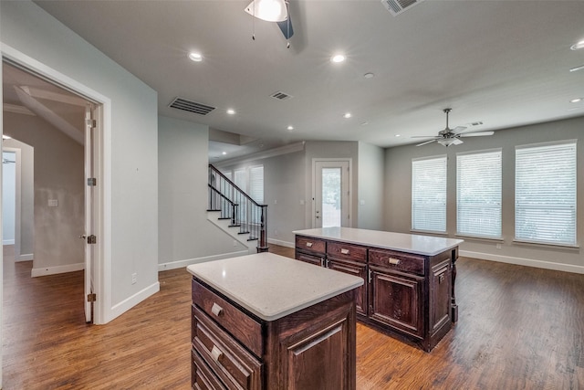 kitchen featuring a kitchen island, hardwood / wood-style floors, and ceiling fan