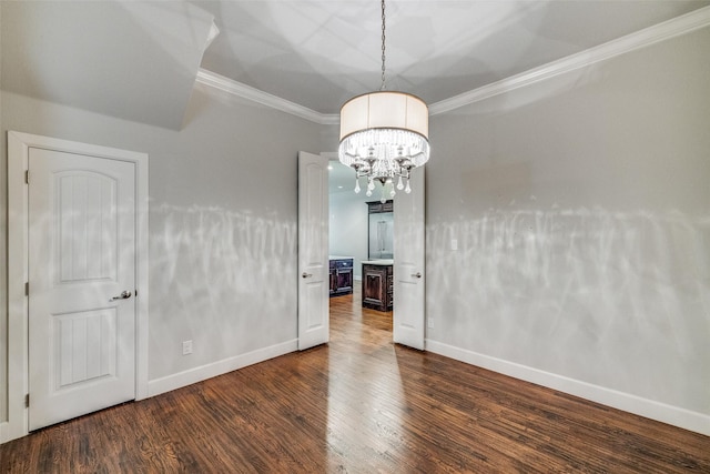 interior space with crown molding, an inviting chandelier, and dark hardwood / wood-style flooring