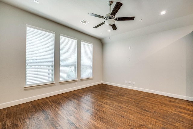 spare room with dark wood-type flooring and ceiling fan