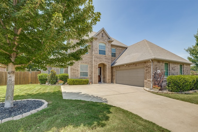 view of front of property with a garage and a front yard