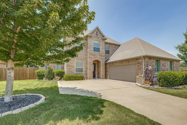 view of front of house featuring a garage and a front lawn