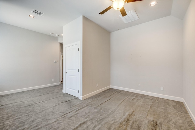 carpeted empty room with vaulted ceiling and ceiling fan