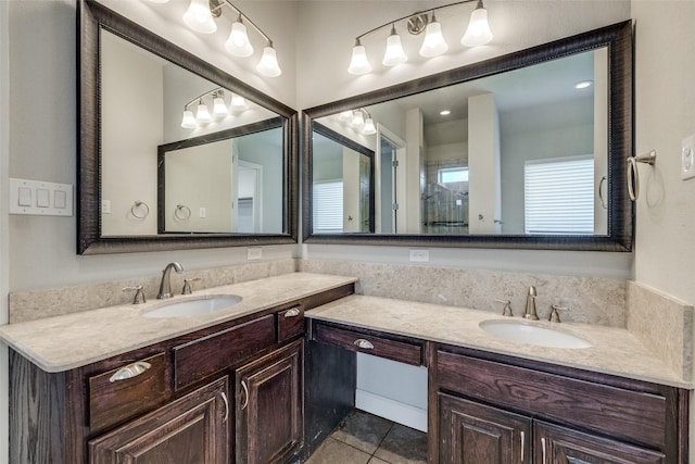 bathroom featuring vanity, tile patterned floors, and a healthy amount of sunlight