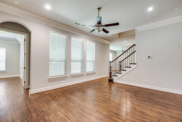 unfurnished living room featuring dark wood-type flooring, ceiling fan, and ornamental molding