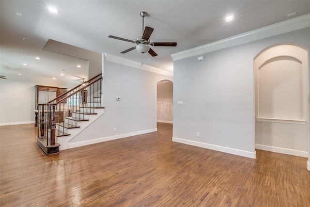 unfurnished living room featuring hardwood / wood-style floors, ornamental molding, and ceiling fan