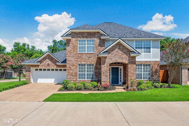 view of front of property with a garage and a front yard