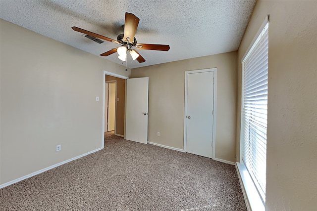 unfurnished bedroom featuring ceiling fan, a textured ceiling, and carpet floors