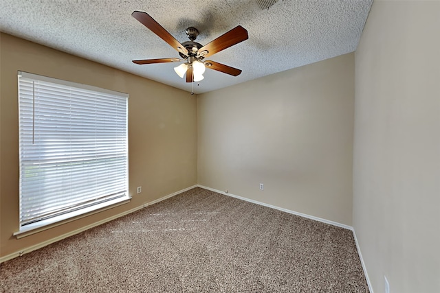 carpeted empty room with a textured ceiling and ceiling fan