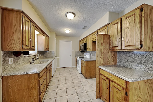 kitchen with backsplash, sink, white appliances, a textured ceiling, and light tile patterned floors