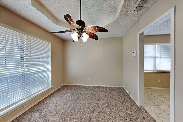 tiled spare room featuring ceiling fan and a textured ceiling