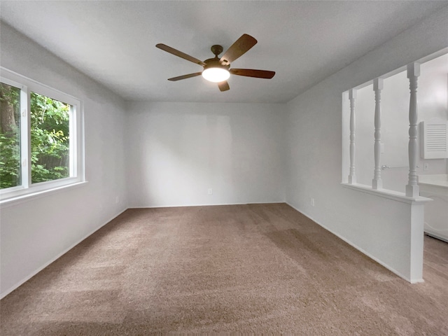 carpeted empty room featuring ceiling fan