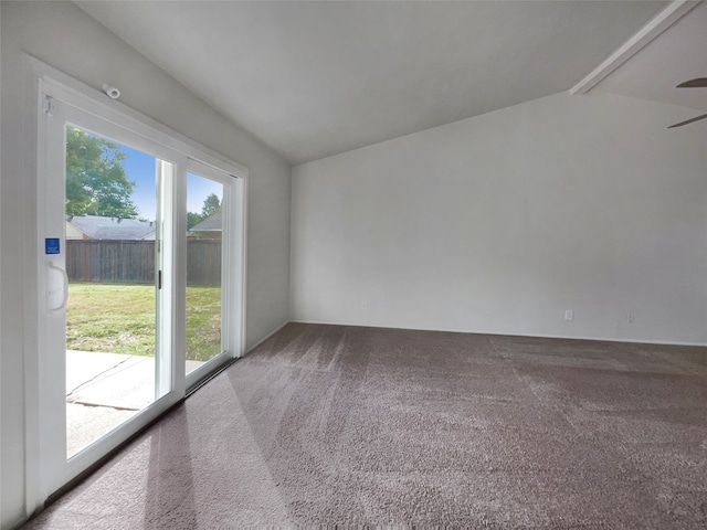 carpeted empty room featuring vaulted ceiling