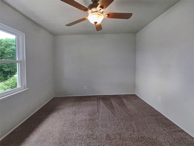 carpeted empty room featuring a healthy amount of sunlight and ceiling fan