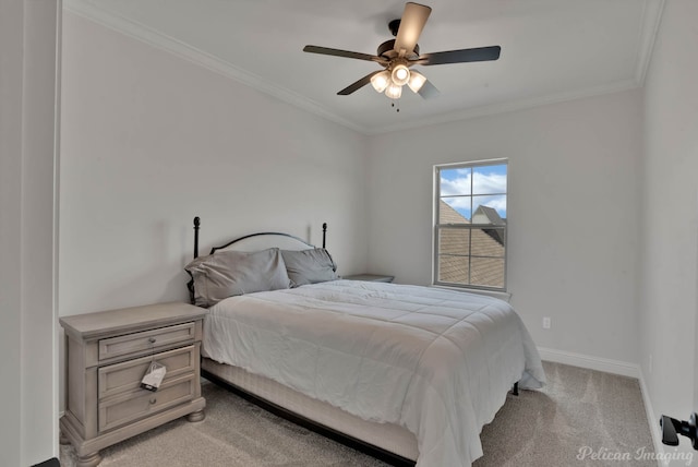 bedroom featuring ornamental molding, light colored carpet, and ceiling fan